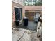 Outdoor patio features gray patio furniture, black trash can, brick wall, and sliding glass door at 4701 Flat Shoals Rd # 65A, Union City, GA 30291