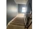 Staircase featuring carpeted steps and wrought iron railings, ascending to the upper levels at 4701 Flat Shoals Rd # 65A, Union City, GA 30291
