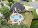Aerial view of backyard featuring a kidney-shaped pool, patio seating, lush greenery, and a well-maintained fence at 503 Chatfield Nw Way, Marietta, GA 30064