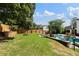 Spacious backyard featuring a well-manicured lawn, stone terrace, fire pit, and in-ground pool at 503 Chatfield Nw Way, Marietta, GA 30064