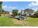 A large backyard with a swimming pool, outdoor furniture, and a stone fire pit, perfect for summer entertaining at 503 Chatfield Nw Way, Marietta, GA 30064