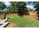 Large backyard featuring well maintained lawn, wooden fence, retaining wall, and stone terrace at 503 Chatfield Nw Way, Marietta, GA 30064