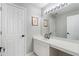 Bright bathroom with double vanity, white cabinets, large mirror, and white doors at 503 Chatfield Nw Way, Marietta, GA 30064