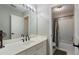 Bright bathroom with a large mirror, white counters, tile walls, and shower/tub combo at 503 Chatfield Nw Way, Marietta, GA 30064