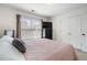 Comfortable bedroom showcases natural light, carpet, a double bed, a dresser, and two closets at 503 Chatfield Nw Way, Marietta, GA 30064