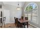 Bright dining area with an elegant light fixture and large window overlooking trees at 503 Chatfield Nw Way, Marietta, GA 30064