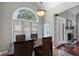 Cozy dining area with dark-stained table and chairs, and an arched window at 503 Chatfield Nw Way, Marietta, GA 30064