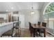 Bright dining area with modern lighting and large window adjacent to the kitchen at 503 Chatfield Nw Way, Marietta, GA 30064