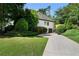 Long driveway leading to a well-maintained home with lush greenery at 503 Chatfield Nw Way, Marietta, GA 30064