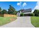 Home exterior showcasing a long driveway, two-car garage, manicured lawn, and established landscaping at 503 Chatfield Nw Way, Marietta, GA 30064