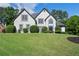 Charming two-story home with a well-manicured lawn and beautiful landscaping at 503 Chatfield Nw Way, Marietta, GA 30064