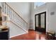 Welcoming foyer with hardwood floors, decorative glass front doors, and elegant staircase with wrought iron spindles at 503 Chatfield Nw Way, Marietta, GA 30064