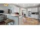 Open-concept kitchen with stainless steel appliances and breakfast bar to adjacent living room at 503 Chatfield Nw Way, Marietta, GA 30064