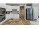 Bright kitchen featuring stainless steel appliances, tile flooring, and white cabinets at 503 Chatfield Nw Way, Marietta, GA 30064