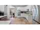Well-lit kitchen with white cabinets, tiled floors, stainless steel appliances, and modern fixtures at 503 Chatfield Nw Way, Marietta, GA 30064