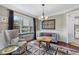 Cozy living room showcasing a bay window, stylish furnishings, and an open view to the adjacent kitchen at 503 Chatfield Nw Way, Marietta, GA 30064