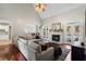 Inviting living room with fireplace, hardwood floors, and a large sectional sofa with backyard pool view at 503 Chatfield Nw Way, Marietta, GA 30064