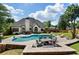 Beautiful backyard with inground pool, dining area, patio furniture, and stone fire pit at 503 Chatfield Nw Way, Marietta, GA 30064