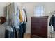Well-organized walk-in closet with clothes racks, shelving, and a wooden chest of drawers at 503 Chatfield Nw Way, Marietta, GA 30064