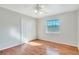 Cozy bedroom with hardwood floors, a ceiling fan, and double door closet at 3137 Buford Ne Hwy # 11, Brookhaven, GA 30329
