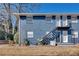 A blue brick apartment building featuring outdoor stairwells and large windows, adding to the aesthetic appeal at 3137 Buford Ne Hwy # 11, Brookhaven, GA 30329
