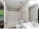 Well-lit bathroom featuring a tub/shower combination with storage shelves at 5290 Forest Downs Ln, Atlanta, GA 30349