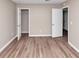 Large bedroom with new floors and access to a closet and the rest of the house at 5290 Forest Downs Ln, Atlanta, GA 30349