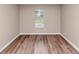 Bedroom featuring new floors and a window overlooking a wooded view at 5290 Forest Downs Ln, Atlanta, GA 30349