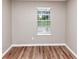 Bedroom featuring new floors and a window overlooking a wooded view at 5290 Forest Downs Ln, Atlanta, GA 30349