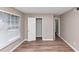 A bright bedroom featuring wood floors, a closet, and natural light at 5290 Forest Downs Ln, Atlanta, GA 30349