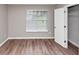 This is a bedroom featuring a window, wooden floor, and a closet at 5290 Forest Downs Ln, Atlanta, GA 30349