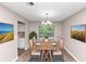 Staged dining room featuring a table with six chairs and decorations at 5290 Forest Downs Ln, Atlanta, GA 30349