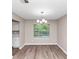An empty dining room with hardwood floors and a chandelier at 5290 Forest Downs Ln, Atlanta, GA 30349