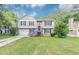 Charming home with a well-manicured lawn, gray siding, and a covered porch entry at 5290 Forest Downs Ln, Atlanta, GA 30349
