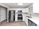 Modern kitchen with stainless steel appliances, white cabinets and countertops at 5290 Forest Downs Ln, Atlanta, GA 30349
