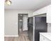 Modern kitchen with stainless steel refrigerator and a view into the entry at 5290 Forest Downs Ln, Atlanta, GA 30349