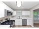 Bright kitchen featuring stainless steel appliances, white cabinets, and ample counter space at 5290 Forest Downs Ln, Atlanta, GA 30349