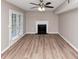 Cozy living room with fireplace, ceiling fan, and access to outdoor area at 5290 Forest Downs Ln, Atlanta, GA 30349