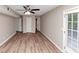 Open living room with ceiling fan, hardwood floors, and patio access at 5290 Forest Downs Ln, Atlanta, GA 30349