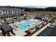 Aerial view of community pool, pavilion, and surrounding apartments, showcasing a great amenity at 707 Dodd N Ln # 164, Buford, GA 30518