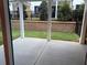 Outdoor living with a covered patio and landscaped backyard with retaining walls and fencing at 707 Dodd N Ln # 164, Buford, GA 30518
