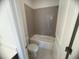 Clean bathroom featuring a tub with tiled walls and a low-flow toilet for water conservation at 707 Dodd N Ln # 164, Buford, GA 30518