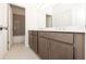 Stylish bathroom boasts dual sinks with modern fixtures, ample cabinet space, and a tiled bathtub at 707 Dodd N Ln # 164, Buford, GA 30518