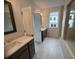 Stylish bathroom featuring dual vanities, a tiled shower, and a window at 707 Dodd N Ln # 164, Buford, GA 30518