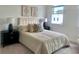 This well-lit bedroom is furnished with nightstands, lamps, and a bed dressed with soft neutral bedding and patterned pillows at 707 Dodd N Ln # 164, Buford, GA 30518