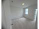 Carpeted bedroom with natural light through a window, offering a cozy atmosphere at 707 Dodd N Ln # 164, Buford, GA 30518
