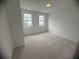 Bright bedroom with dual windows and neutral carpeting, perfect for personalization and comfort at 707 Dodd N Ln # 164, Buford, GA 30518