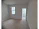 Comfortable carpeted bedroom filled with natural light from a window, and a door leading to balcony at 707 Dodd N Ln # 164, Buford, GA 30518