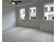 A bright bedroom with large windows and a ceiling fan at 707 Dodd N Ln # 164, Buford, GA 30518