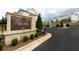 The Millcroft community entrance features a stone monument, lush landscaping, and an electronic gate for residents at 707 Dodd N Ln # 164, Buford, GA 30518